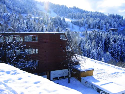 a building on top of a snow covered mountain at Hôtel Arcadien in Arc 1600