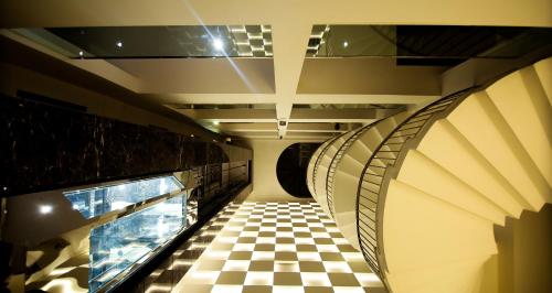 a hallway with a checkered floor in a train at Hotel The Prime Balaji Deluxe, City Centre, With Free Airport Pickup in New Delhi