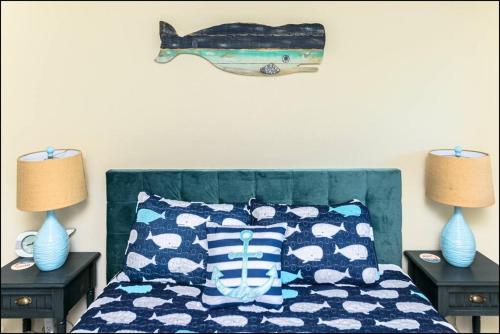 a bedroom with a bed with a fish on the wall at Sea Star Condo in Ocean Shores