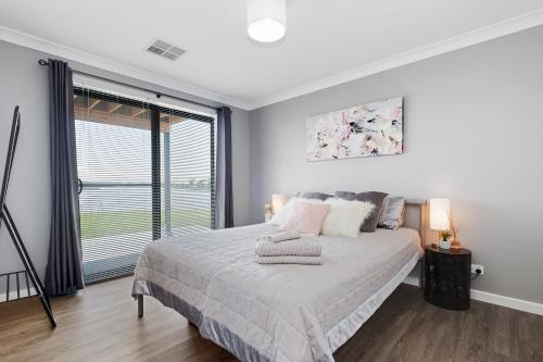 a bedroom with a bed and a large window at 33 Jefferson Court, Wellington East in Wellington East
