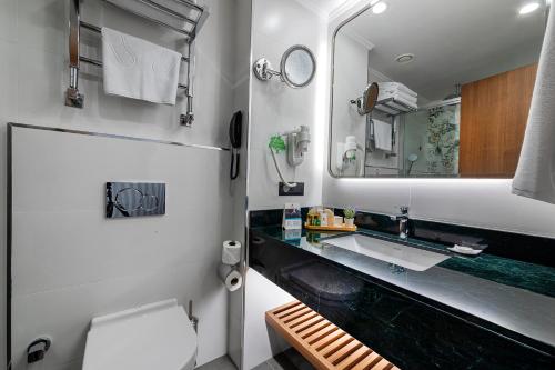 a bathroom with a sink and a mirror at Mukarnas Pera Hotel in Istanbul