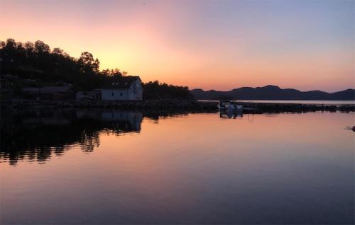 a sunset over a body of water with a house at 3 Bedroom Amazing Home In Skjold in Skjold