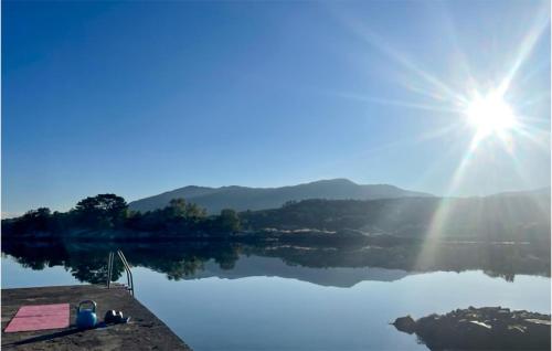 a view of a lake with the sun shining on it at 3 Bedroom Amazing Home In Skjold in Skjold