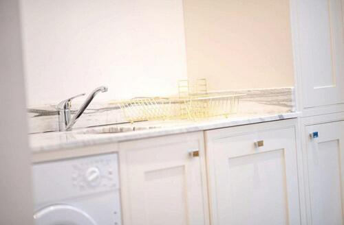 a bathroom with a sink and a washing machine at TempleTwenty5 by 360 Stays - Highly Rated Oxford Home with Parking in Oxford