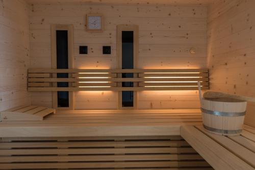 a sauna with a bench in a wooden room at MESNERHOF CHALET - Ruhe, Rückzug & Südtiroler Charme mit kostenlosem Parken in der Tiefgarage in Bressanone