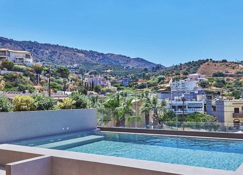 a swimming pool on the roof of a building at Castello Infinity Suites - Adults Only in Agia Pelagia