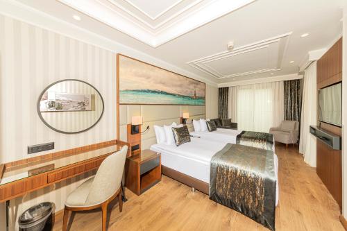 a hotel room with a bed and a television at Mukarnas Pera Hotel in Istanbul
