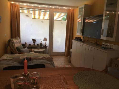 a living room with a table and a large window at Appartement Lotte in Kiel