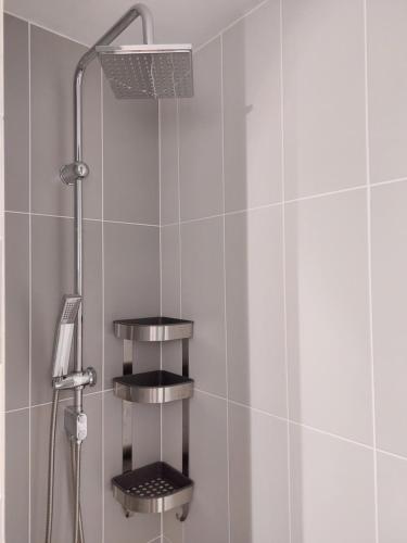 a shower with two shelves in a bathroom at STUDIO 22 in Craiova