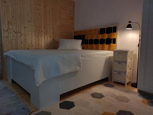 a bedroom with a large bed and a night stand at STUDIO 22 in Craiova