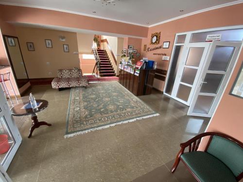 a living room with a couch and a rug at Tagaytay Karakol Hotel in Karakol