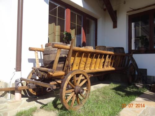 a wooden wagon sitting outside of a building at Alpenhof Pansion in Slavske