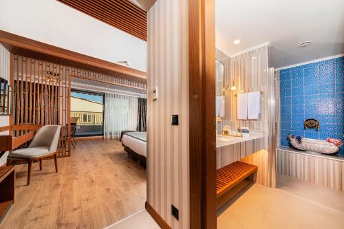 a bathroom with a sink and a bed in a room at Mukarnas Pera Hotel in Istanbul