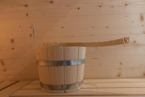 a wooden cup with a stick in a room at MESNERHOF CHALET - Ruhe, Rückzug & Südtiroler Charme mit kostenlosem Parken in der Tiefgarage in Bressanone