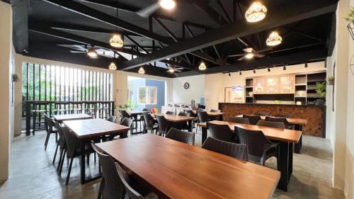 a dining room with wooden tables and chairs at Bill Tourist Inn in El Nido