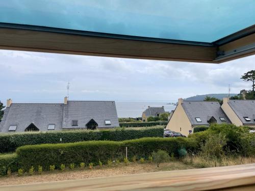 a view of a row of houses from a window at Ty Cèdre in Crozon