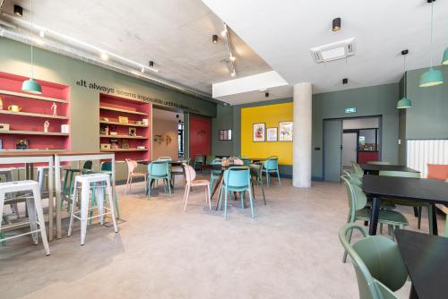 a restaurant with tables and chairs in a room at Student Factory Montpellier Sud in Montpellier
