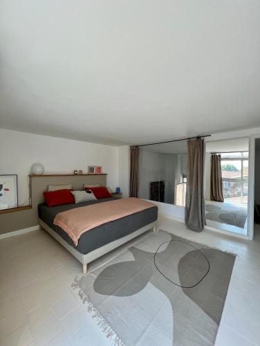 une chambre avec un lit et une grande fenêtre dans l'établissement Duplex le Saint Paul, à Arles