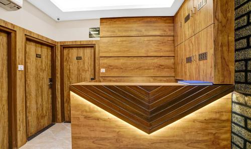 a dressing room with wood paneling and a wooden wall at Itsy By Treebo - Heraa International in Mumbai
