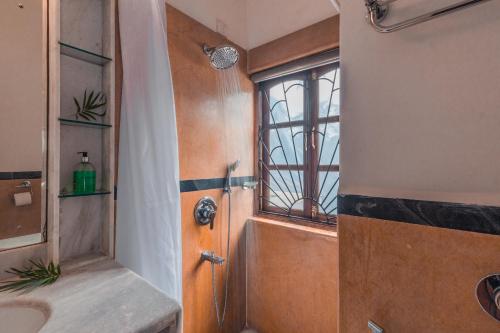 a bathroom with a shower and a sink at Beachfront mansion with pool in Calangute