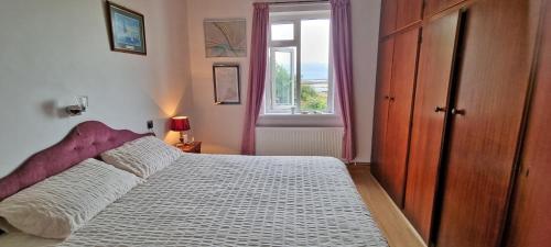 a bedroom with a large bed and a window at Bealadangan Holiday Home 