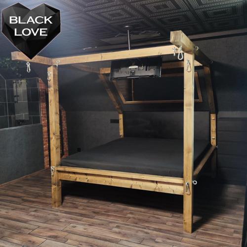 a bunk bed in a room with a sign that reads black love at Love Apartmanok Eger in Eger