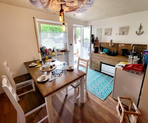a kitchen and dining room with a table and a refrigerator at SeeOase in Muhr am See inkl Frühstück in Muhr amSee