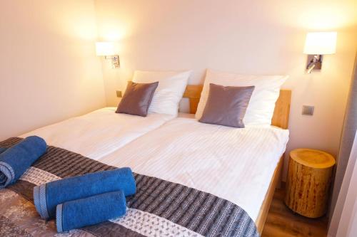 a bedroom with a large white bed with two pillows at MALINOWA OSADA in Wisła
