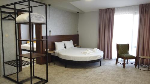 a bedroom with a bed and a book shelf at Clepsydra Residence in Plovdiv