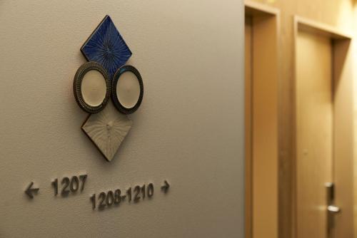 a pair of scissors hanging on a wall next to a door at CROSS Life Hakata Yanagibashi in Fukuoka