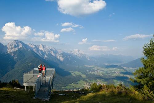 two people standing on top of a lookout tower on a mountain at Carina's Apartment in Obsteig
