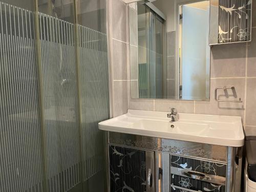 a bathroom with a sink and a mirror at Premiere Haven MOA Staycation in Manila