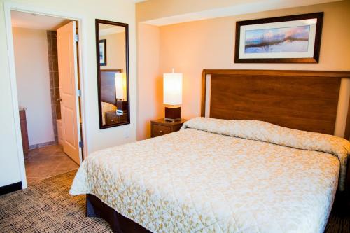 a hotel room with a bed and a mirror at Towers at North Myrtle Beach in Myrtle Beach