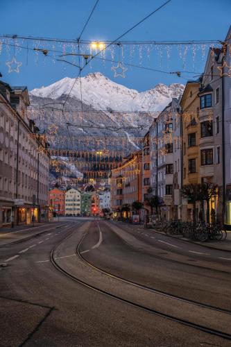 an empty street with a mountain in the background at Carina's Apartment in Obsteig