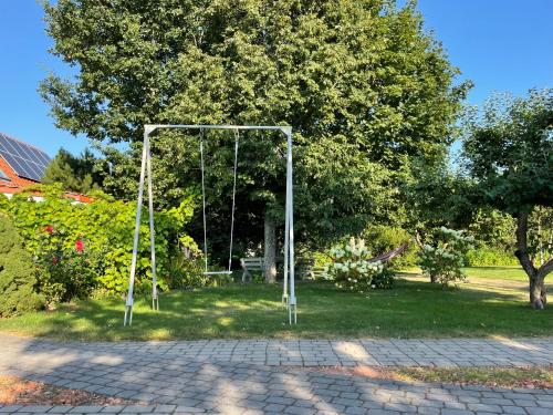a swing set in the middle of a park at Mono House in Rusnė