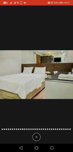 a picture of a bedroom with two beds in it at Tai Hoe Hotel Pengerang in Kampung Sungai Rengit