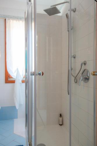 a shower with a glass door in a bathroom at Villa Mariel Suites & Apartment in Massa Lubrense