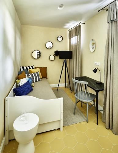a bedroom with a bed and a desk and a table at Zámek Žďár in Žďár nad Sázavou