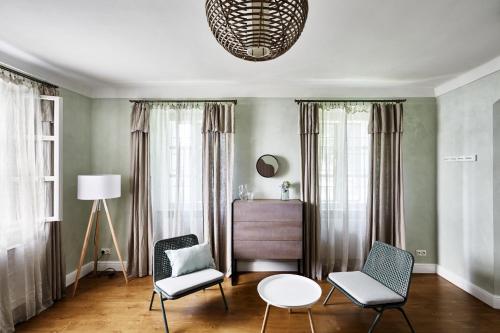 a living room with two chairs and a table at Zámek Žďár in Žďár nad Sázavou