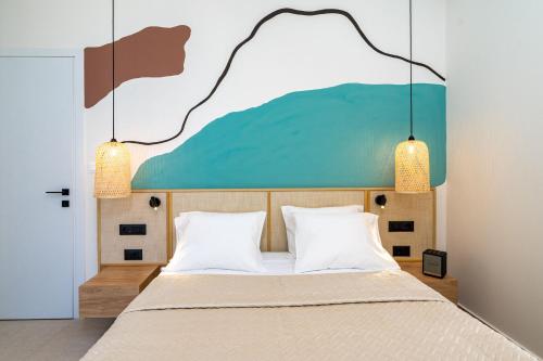 a bedroom with a bed with a painting on the wall at KoNoSo Luxury Apartments in Heraklio Town