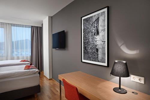 a hotel room with a bed and a table with a lamp at Reykjavik Natura - Berjaya Iceland Hotels in Reykjavík