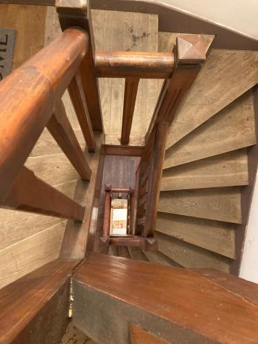 an overhead view of a wooden staircase with wooden beams at LE STUDIO COLBERT - plein centre à petit prix - in Rethel