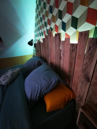 a bed in a room with a wooden wall at L'Effet Mer, maison d'exception in Berck-sur-Mer