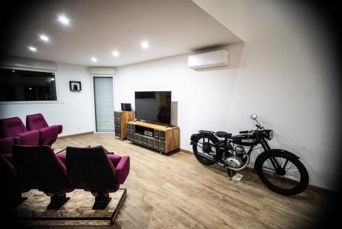 a living room with a motorcycle parked in a room at L'Effet Mer, maison d'exception in Berck-sur-Mer