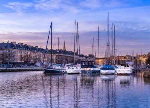 a group of boats are docked in a harbor at Studio Cosy Centre ville in Caen