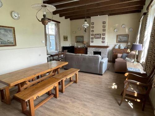 a living room with a table and a couch at Villa Sint Anna in Sint Anna ter Muiden