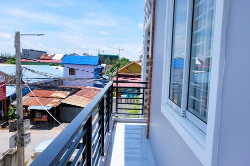 a balcony with a view of a city at Kampot Coco Guest House in Kampot