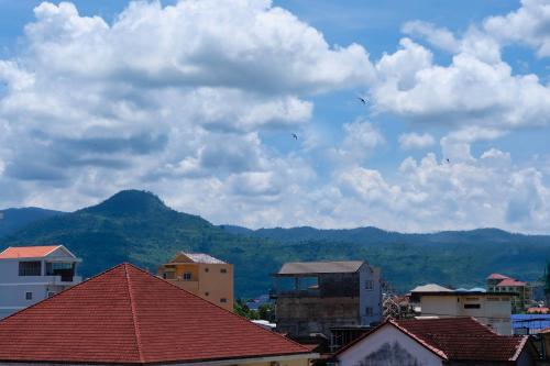 a group of buildings with kites flying in the sky at Kampot Coco Guest House in Kampot