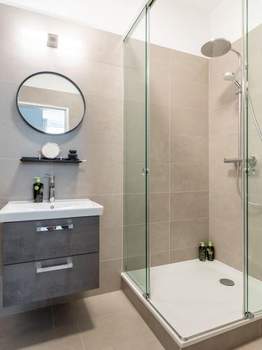 a bathroom with a shower and a sink and a mirror at Limehome Berlin Luise Henriette Str - Digital Access in Berlin