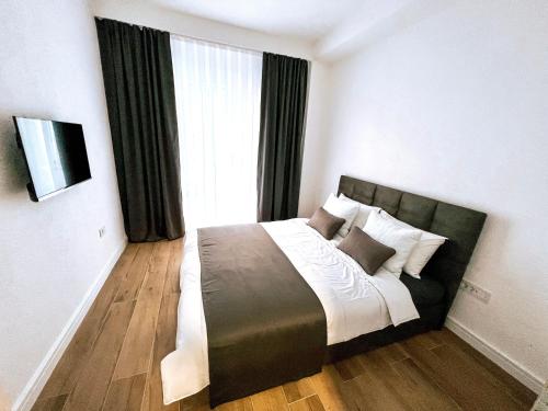 a bedroom with a large bed in front of a window at Luxury apartment Struga in Struga